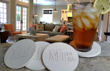 Mr. and Mrs. drink coasters sitting on a table in the living room.